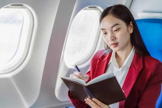 Woman Working And Update With Calendar, Schedule, Timetable, And Management, Event Planning Sitting In Airplane.