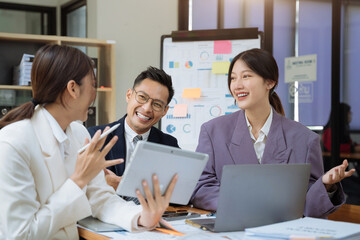 Businessmen team or financial data analysts working with tablets and laptop computers and data graphs together. Plan to analyzing projects in the office.