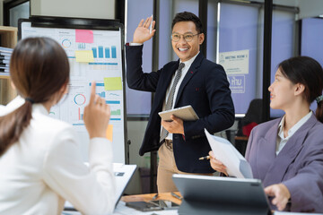 Group of Young Asian business team creative businesspeople coworker in office. Meeting Presentation for analysis graph company financial. People Work in Business Office.