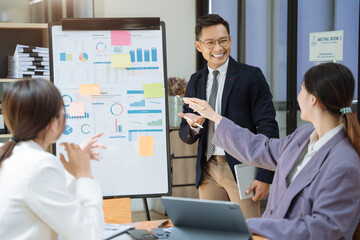 Group of Young Asian business team creative businesspeople coworker in office. Meeting Presentation for analysis graph company financial. People Work in Business Office.
