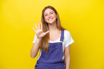 Young caucasian woman isolated on yellow background counting five with fingers