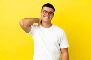 Young handsome man over isolated yellow background laughing - obrazy, fototapety, plakaty