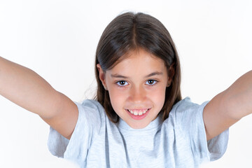 Photo of Beautiful little kid girl wearing blue T-shirt do selfie