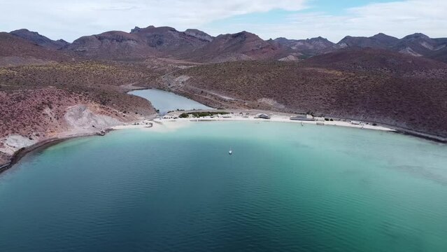 Aerial view of the breathtaking Playa Pichilingue near Pichilingue port of La paz in Baja California Sur Mexico with blue sea with floating ships and rocky landscape