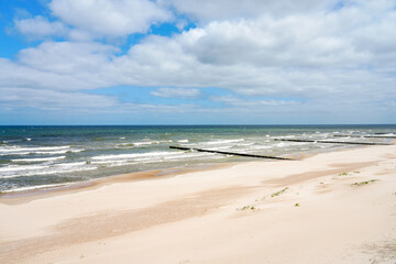 Fototapeta na wymiar Beach near Trzesacz in Poland. Natural coast on the Polish Baltic Sea with white sand. Landscape by the sea in West Pomerania.