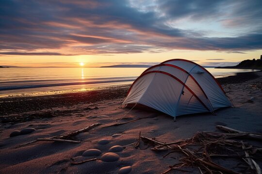 a tent pitched on a beach at dawn