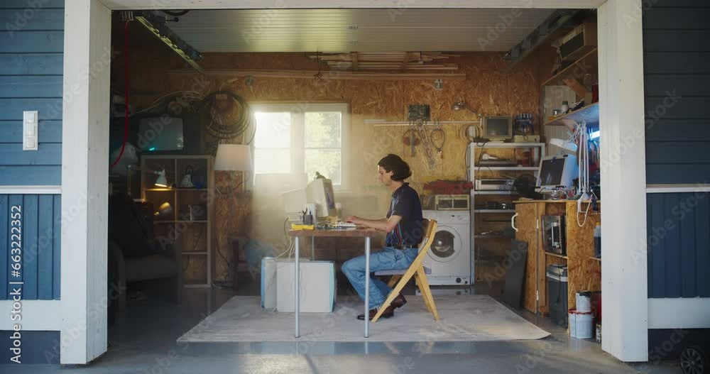 Poster Caucasian Male Software Engineer Programming On Old Desktop Computer In Retro Garage With Random Appliances. Man Working On Innovative Fintech Startup Company In Nineties. Nostalgia Concept.