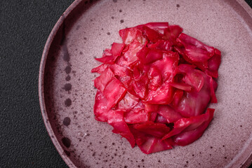 Delicious spicy pink cabbage sliced and cooked in Korean style on a ceramic plate
