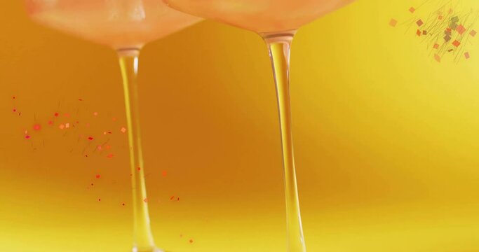 Animation of confetti falling and cocktail on yellow background
