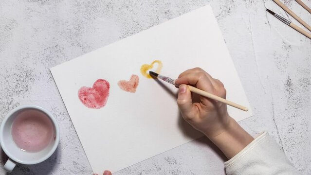 Stop motion of female hand painting balloons in heart shape with words equality diversity identity equity inclusion. Concept of creative Motivational Words Quotes pride month. Equal rights support