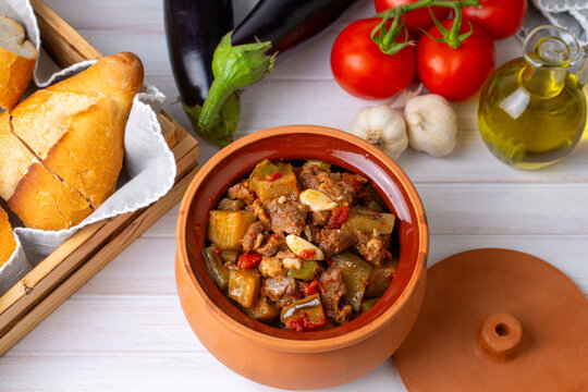 Top view of Turkish dish Guvech - baked meat with eggplant and traditionally served in earthenware pot (Turkish name; etli patlican guvec or patlican tava)