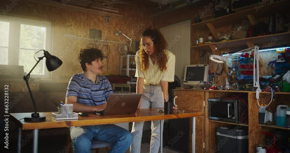 Poster caucasian male software developer and hispanic female business partner talking and using laptop comp