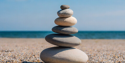 Fototapeta na wymiar stone tower natural pebble stone on the beach balancing body mind soul and spirit mental hea