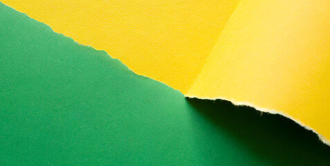 tapering shaped torn green and yellow paper 