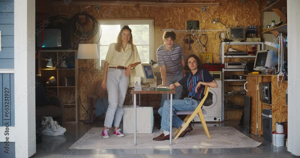 Leinwandbilder diverse team of three young startup company founders in retro garage with old desktop computer. male