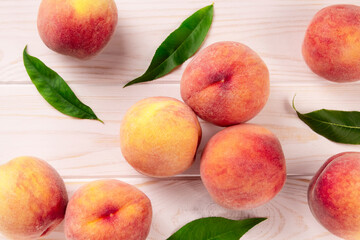 Fresh peaches on a wooden table.