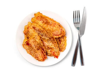 Breaded Peppers (Pohovane Paprike), Balkan cuisine specialty. Fried paprika served on a plate with knife and fork