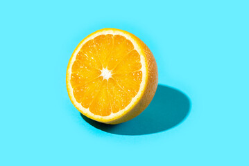 Ripe and fresh orange slice on blue background. Vitamins Healthy Diet Summer Superfoods Concept. Food Poster Banner Template. Copy Space