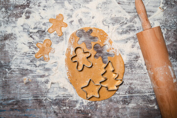 Raw Christmas Cookies. The process of making gingerbread with cookies cutters.