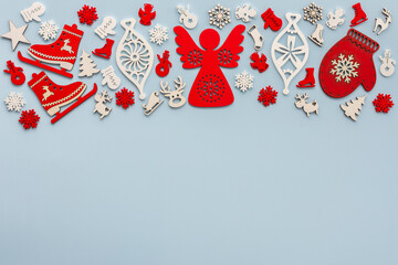 White and red Christmas toys on a blue background, Merry Christmas and Happy New Year concept, top view, copy space