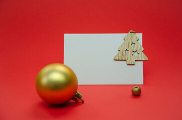 Christmas composition on a red background. Fir branches, red decorations, copy space.
