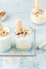 Milk mousse dessert with nuts in glasses