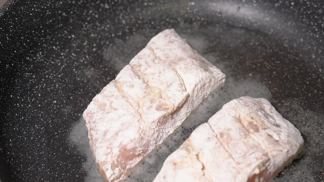 Frying fresh zander fillets, on a frying pan