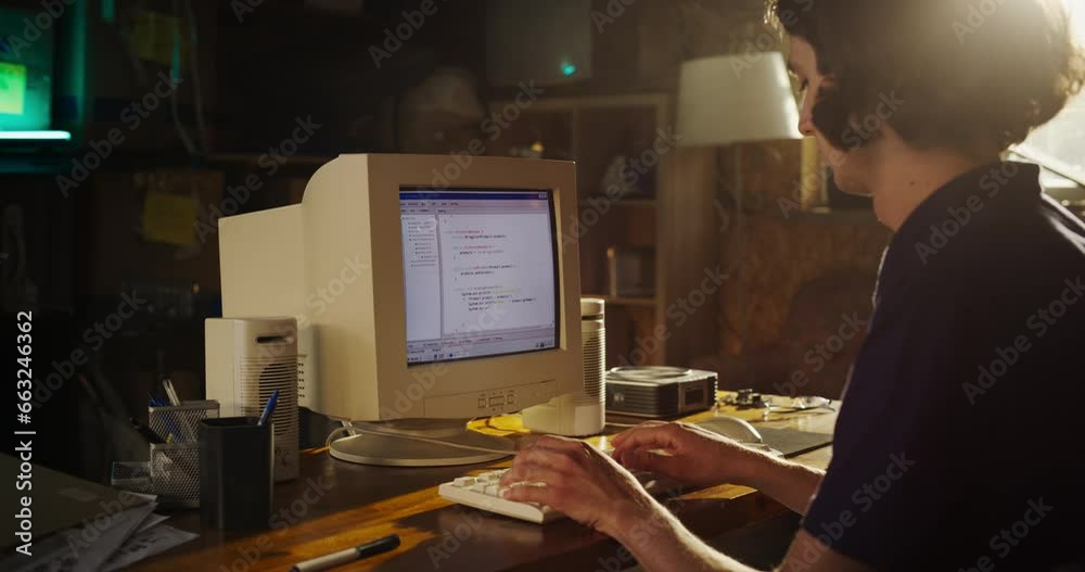 Poster Side View Of Caucasian Male Software Engineer Programming on Old Desktop Computer In Retro Garage. Focused Man Starting Tech Startup Company In Nineties. Coding Innovative Online Service At Home.