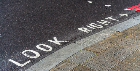 Look Right instructions written on a road surface at a junction - obrazy, fototapety, plakaty