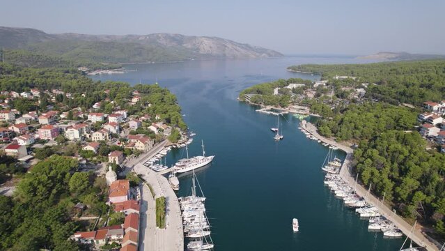 Aerial Stari Grad, Hvar: Marina, boats, and town by serene Croatian waters