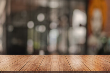 Empty wooden table top with lights bokeh on blur restaurant background.	
