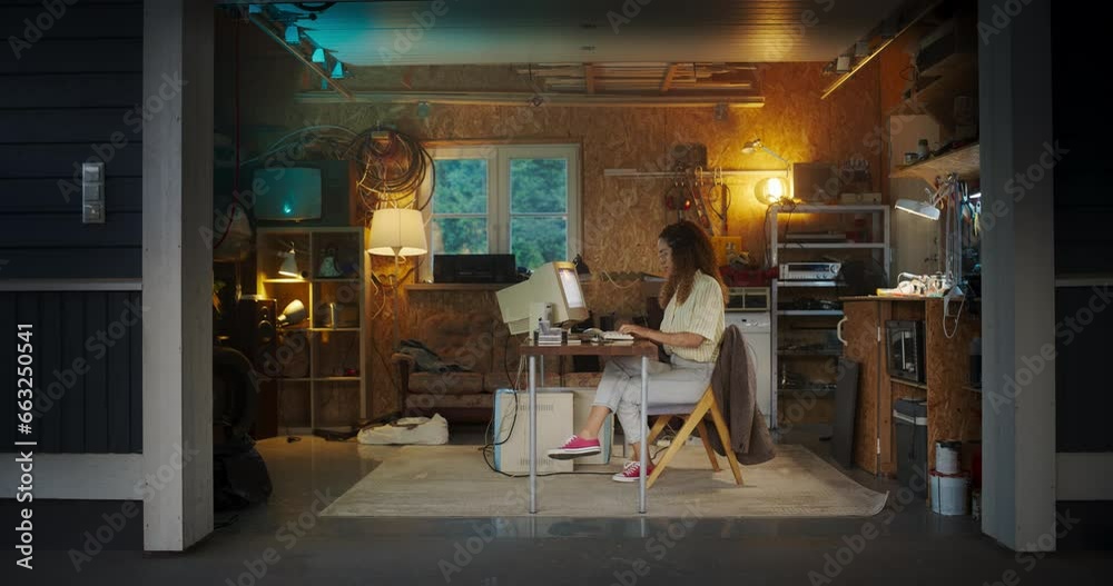 Leinwandbilder hispanic female developer programming on old desktop computer in retro garage in the evening. young 
