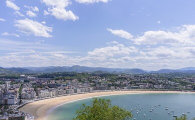 Fototapeta na wymiar Panoramic aerial view of San Sebastian (Donostia) on a summer day with some clouds in the sky, Spain
