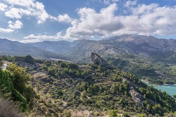 Guadalest, rocky mountains with abundant green vegetation.