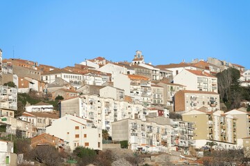 Fototapeta na wymiar Medieval village of Bejar at sunset with houses stacked on top of the mountain. Salamanca. Spain.