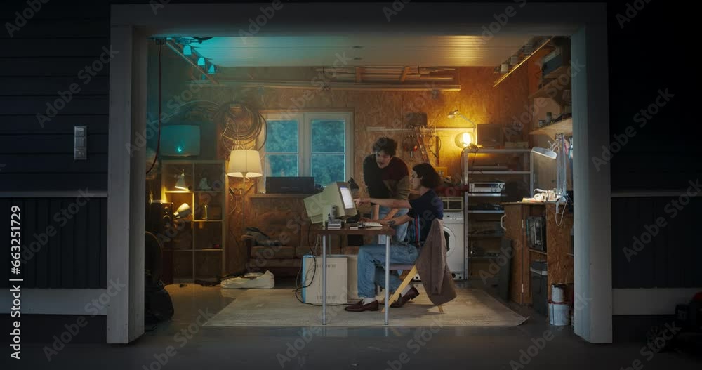 Poster Two Caucasian Male Tech Startup Founders Using Old Desktop Computer In Retro Garage In The Evening. Software Developer And User Experience Designer Starting New E-commerce Business In Nineties.