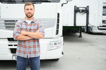 Portrait of trucker standing by his truck ready for driving. Driver occupation. Transportation services
