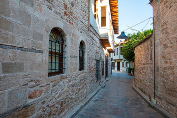 Fototapeta na wymiar Charming stone street surrounded by old medieval-inspired houses.