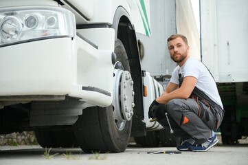 Professional truck mechanic working in vehicle repair service.