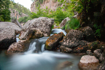 Naklejka na ściany i meble Koprulu Canyon in Antalya. Water flowing naturally into the lake through the stones and rocks. Natural waterfall.Antalya,Turkey.