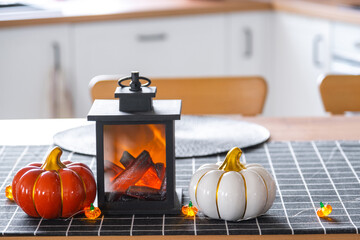 Decor of white classic kitchen with pumpkins, garlands, latern for Halloween and harvest with...
