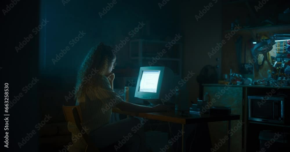Poster hispanic female programmer using old desktop computer in retro garage late at night. white hat hacke