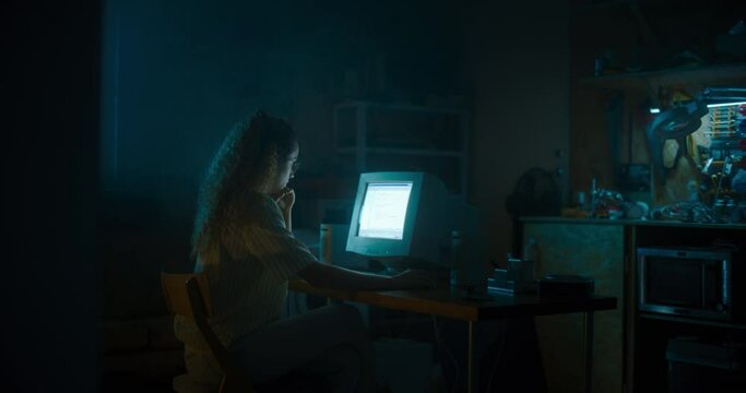 Hispanic Female Programmer Using Old Desktop Computer In Retro Garage Late At Night. White Hat Hacker Searching For Software Vulnerabilities, Coding Cyber Security System, Protecting Data In Nineties.