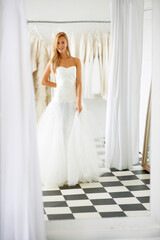Fototapeta premium Wedding, dress and portrait of young bride in a luxury boutique, shop or store in a mall. Retail, style and female person from Canada preparing for marriage ceremony, party or reception for love.