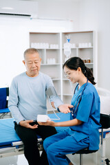 Obraz premium Female doctor holding male patient hand on the bed with receiving saline solution in hospital or clinic..