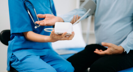 Female doctor holding male patient hand on the bed with receiving saline solution in hospital or clinic..