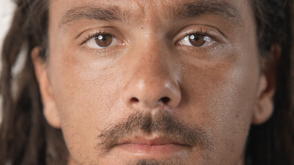 Obraz premium Handsome person look at camera close up. Young adult man face portrait. Stylish 30s guy on isolated white background. Attractive male model. Modern millennial people. Brutal bearded style. Barber shop