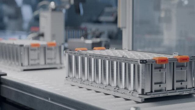 Close-up of Automotive Battery Module on Conveyor Belt. Automated Production Line. Advanced and Modern EV Factory. Electric Car Battery Pack Manufacturing Process. 