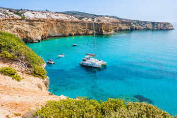 View of catamaran boat on sea coast near Tsigrado beach, Milos island, Cyclades, Greece - 663264335