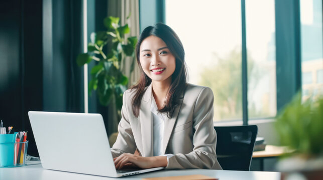 Young asian business woman using a laptop in the office